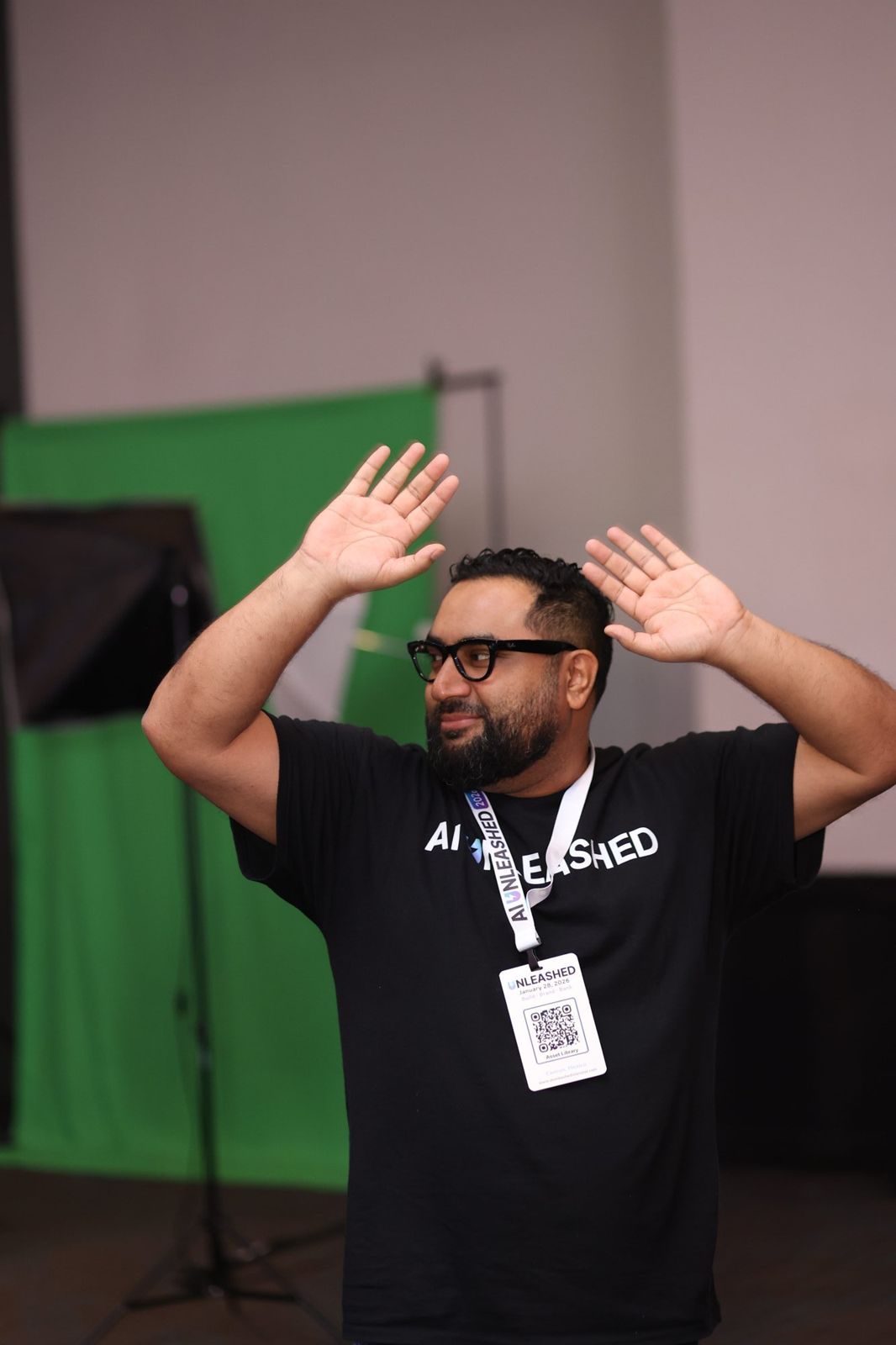 Fer Patel with hands raised, mid-story