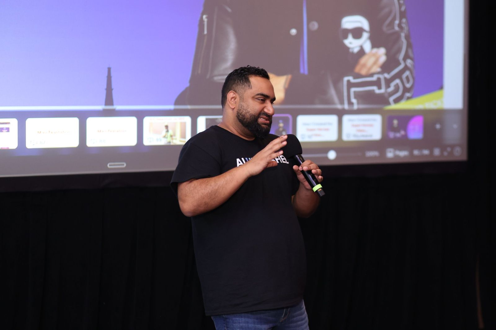 Fer Patel presenting on stage in front of a HighLevel screen
