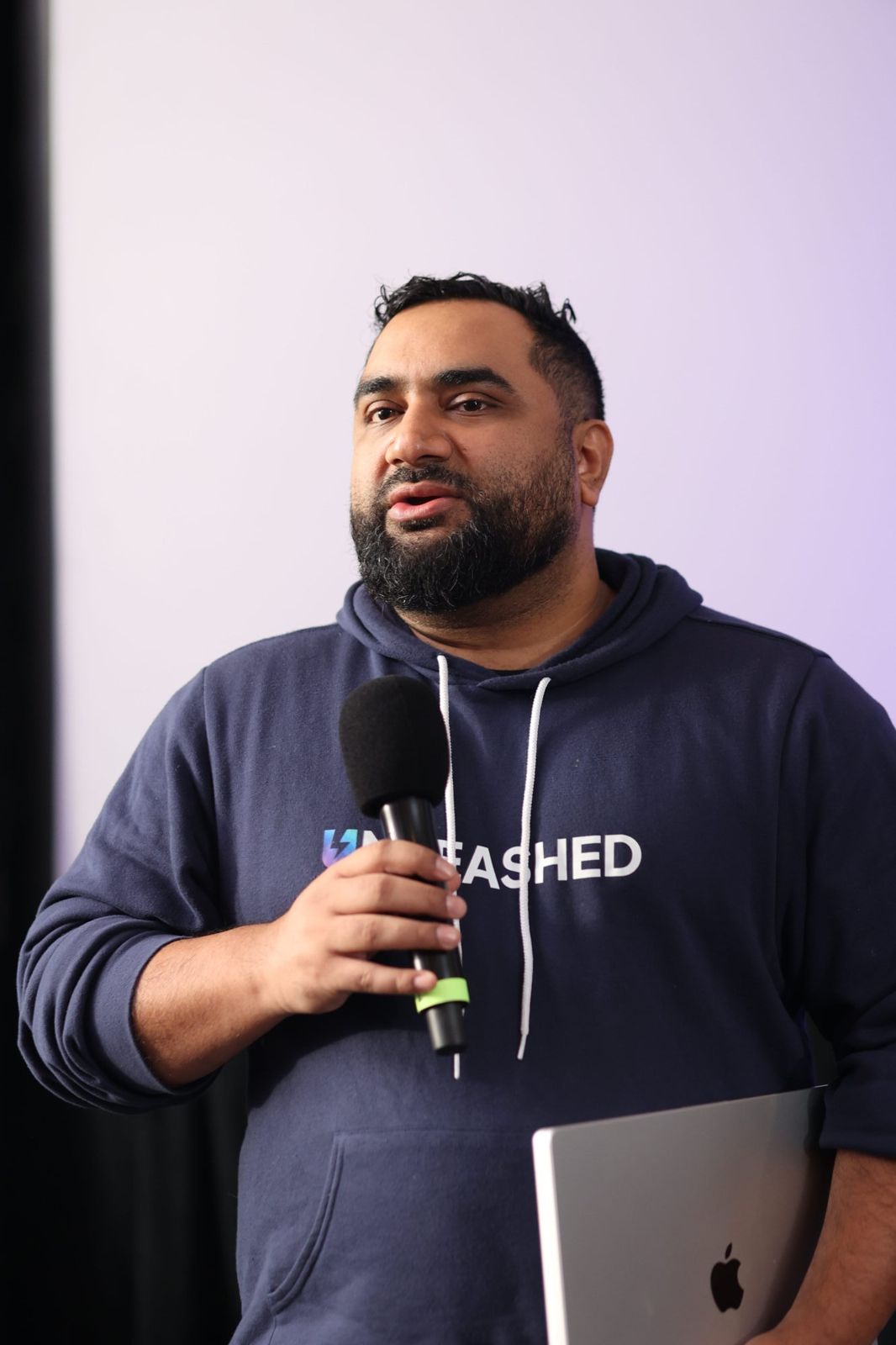 Fer Patel speaking on stage at AI Unleashed