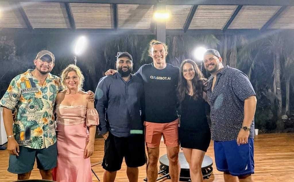 Fer with fellow speakers at an evening event