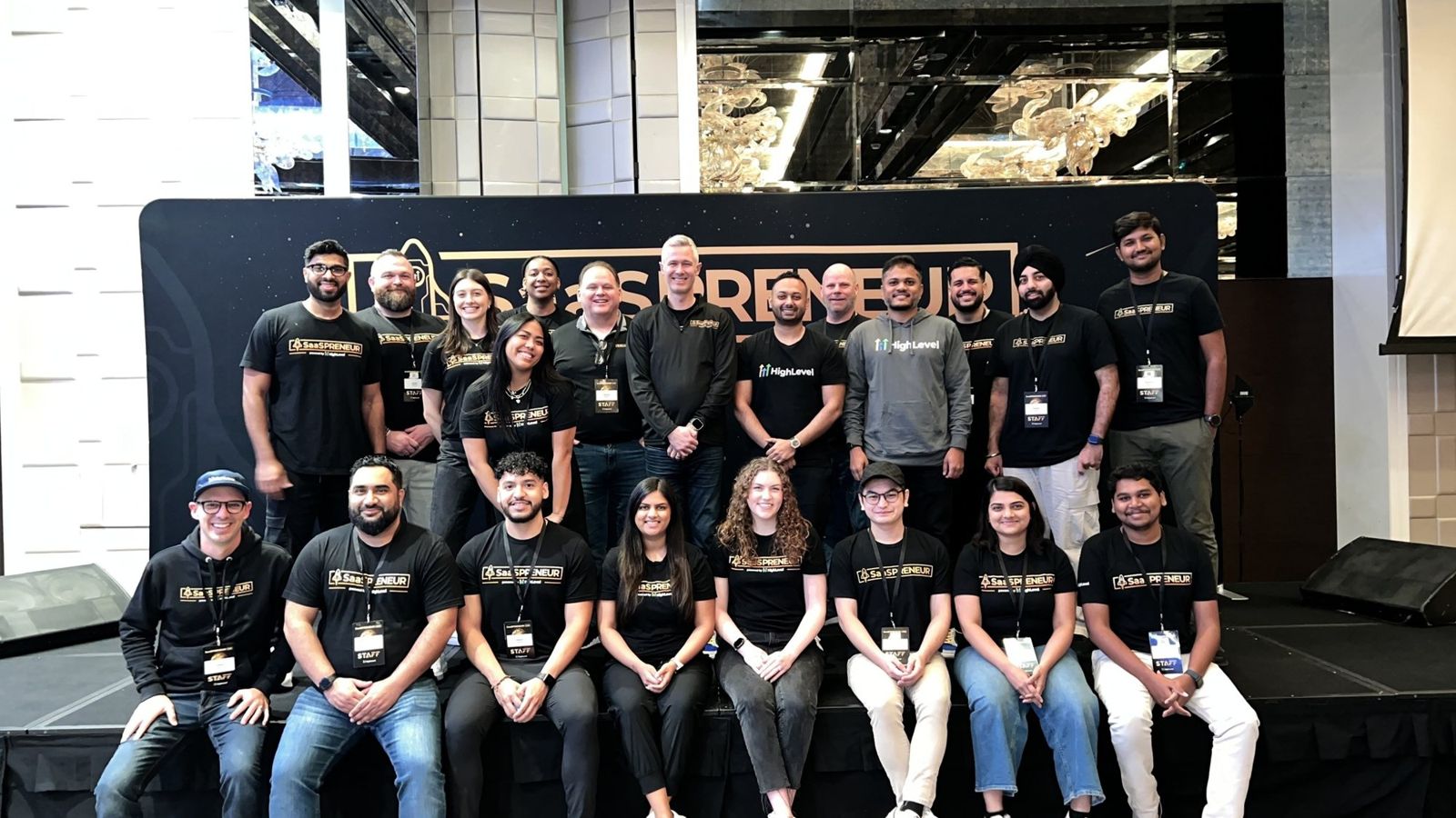 Fer with the SaaSPRENEUR staff team on stage